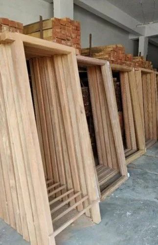 Premium natural wooden door frames in workshop